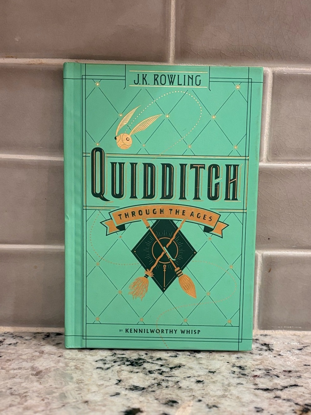 Scholastic Teal and Gold Quidditch Through the Ages Hardcover